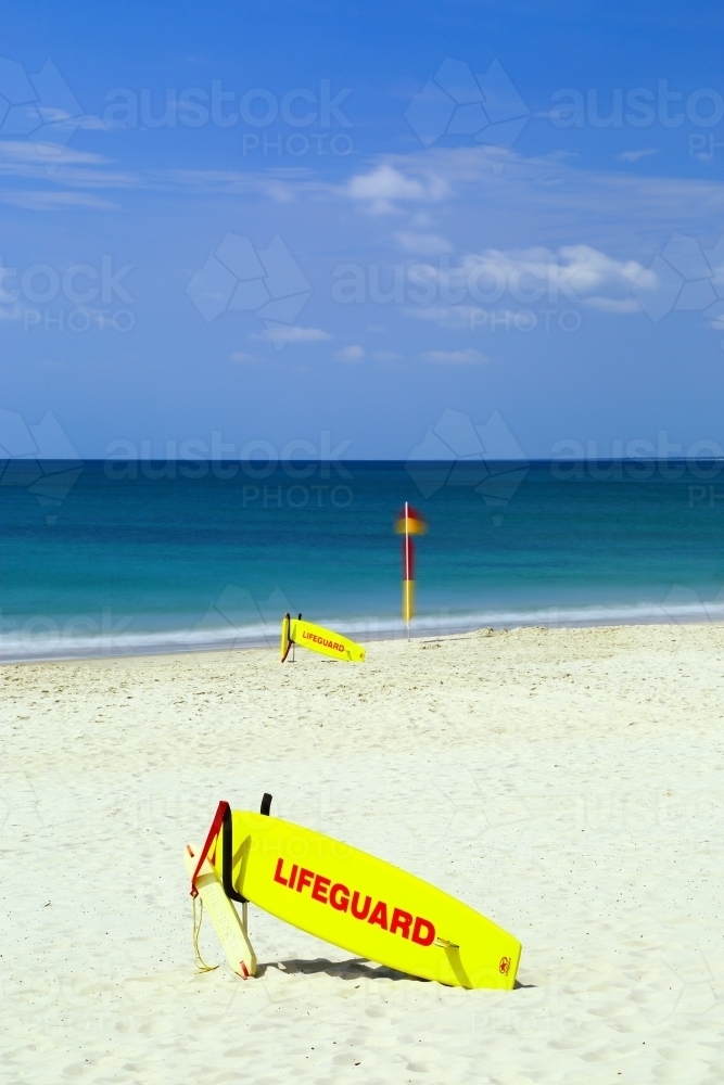 Sunlit surf lifeguard equipment on Kings Beach - Australian Stock Image