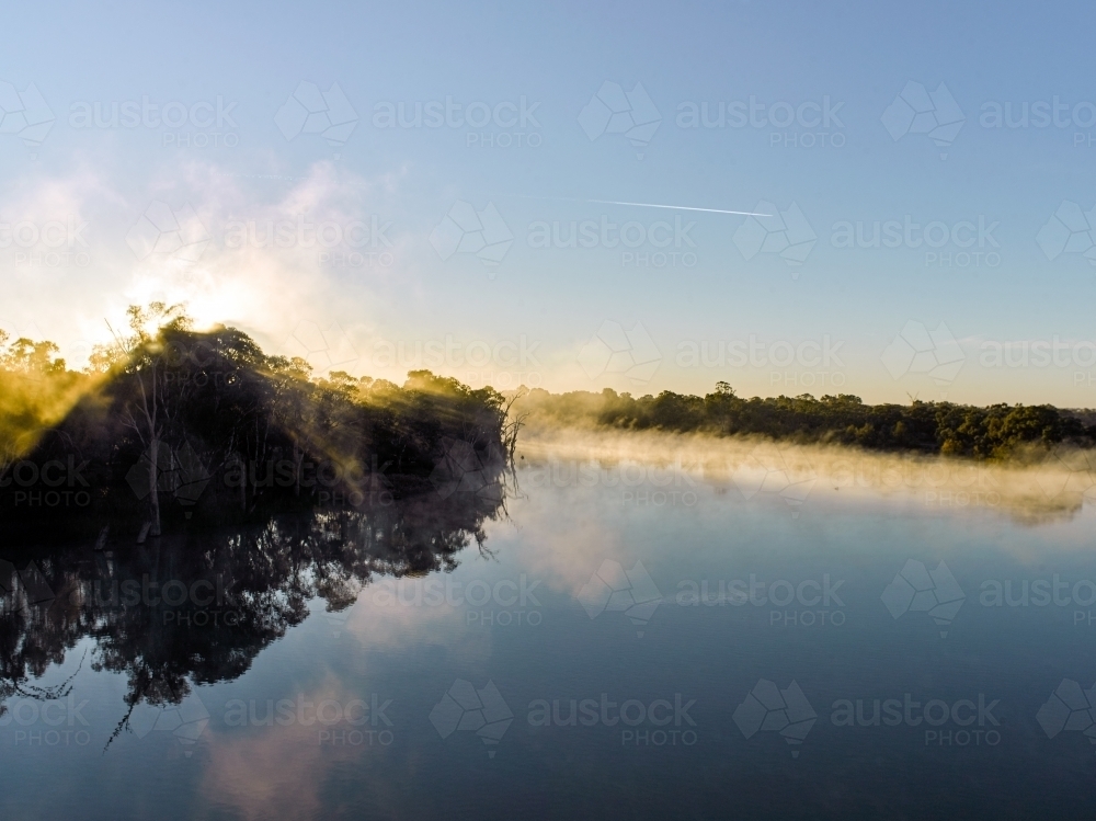 Sunrise and mist on river in the country - Australian Stock Image