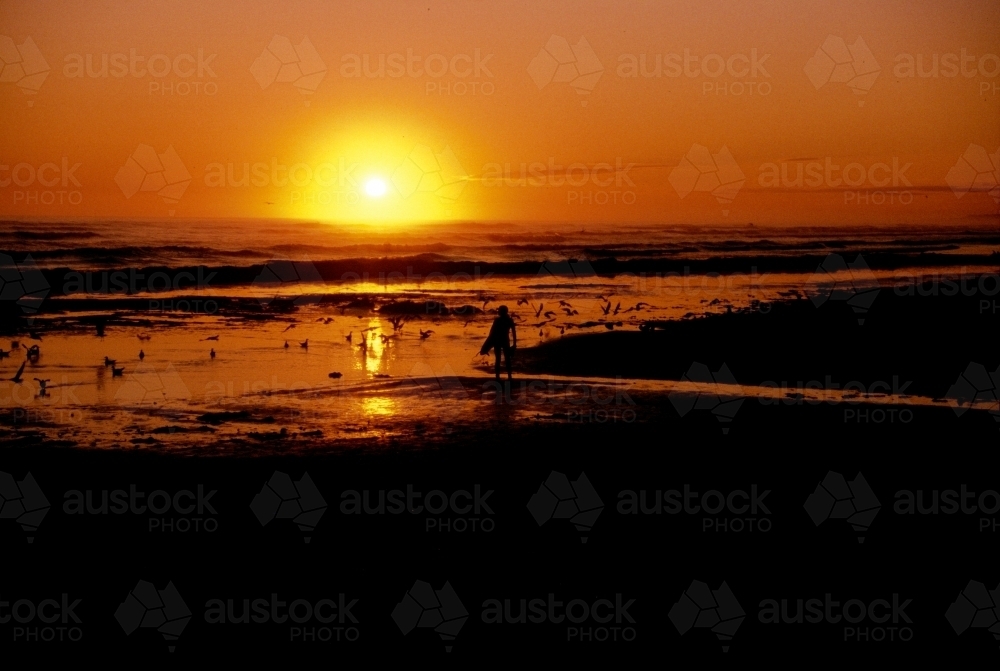 Sunrise and surfer - Australian Stock Image