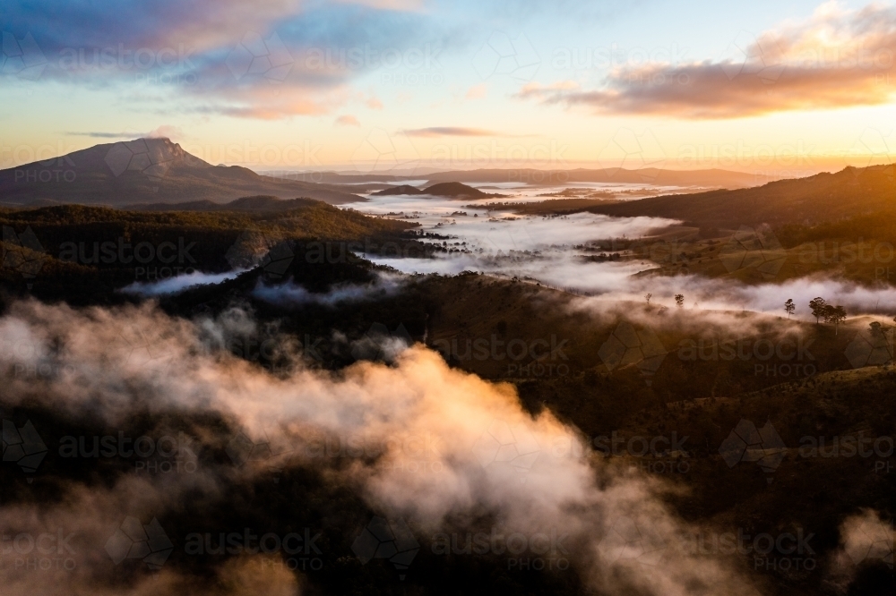 Sunrise fog around Mount Maroon, Scenic Rim, Queensland Australia - Australian Stock Image