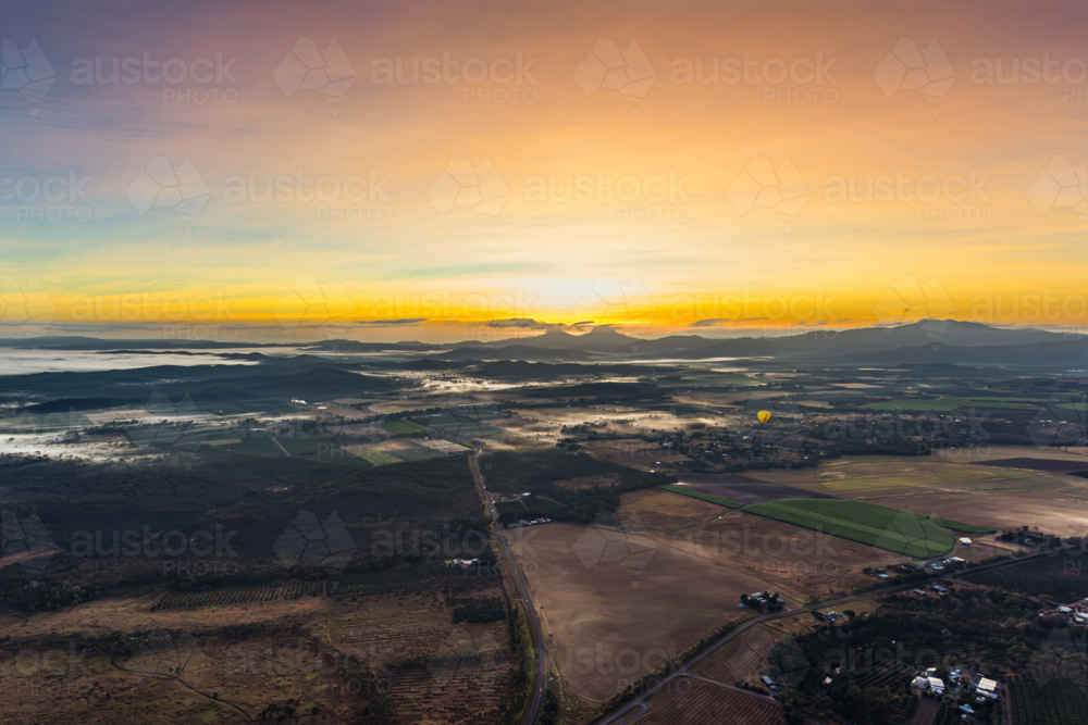 Sunrise hot air balloon ride over Mareeba in the Atherton Tablelands - Australian Stock Image