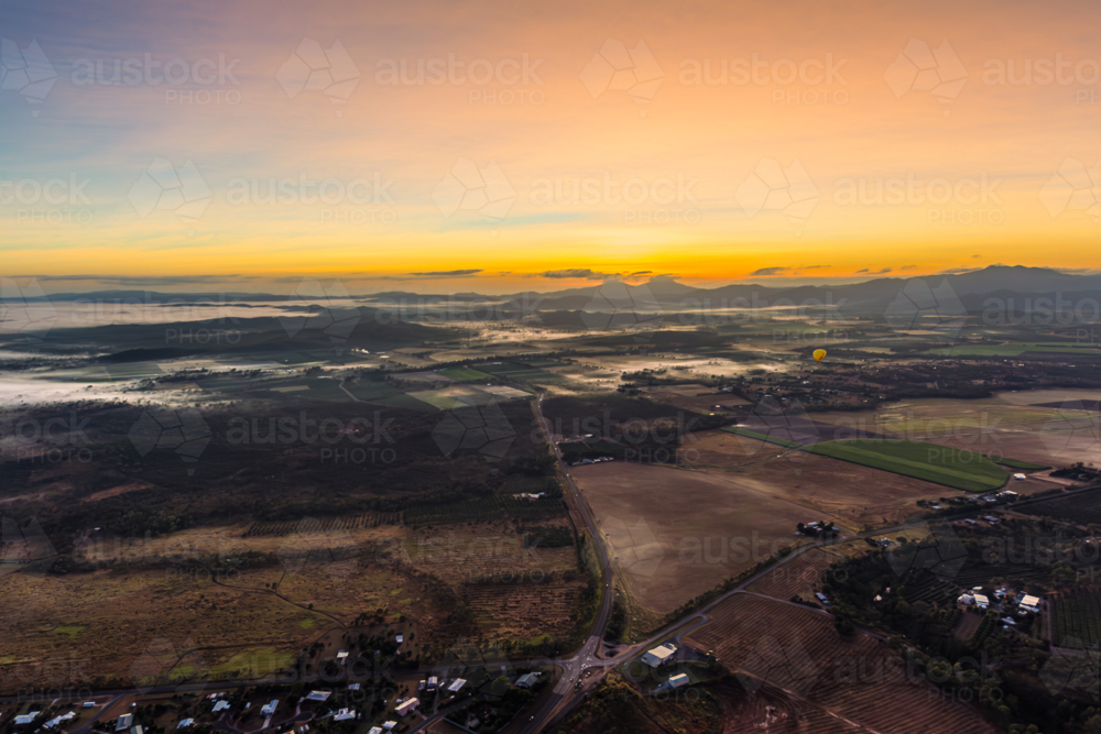 Sunrise hot air balloon ride over Mareeba in the Atherton Tablelands - Australian Stock Image