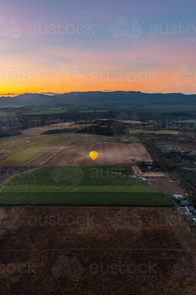 Sunrise hot air balloon ride over Mareeba in the Atherton Tablelands - Australian Stock Image