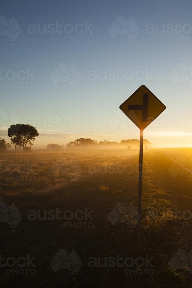 Sunrise in regional highway with Sign in the foreground - Australian Stock Image