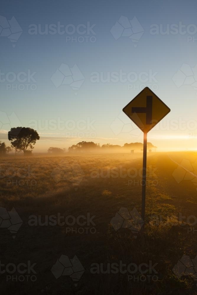 Sunrise in regional highway with Sign in the foreground - Australian Stock Image