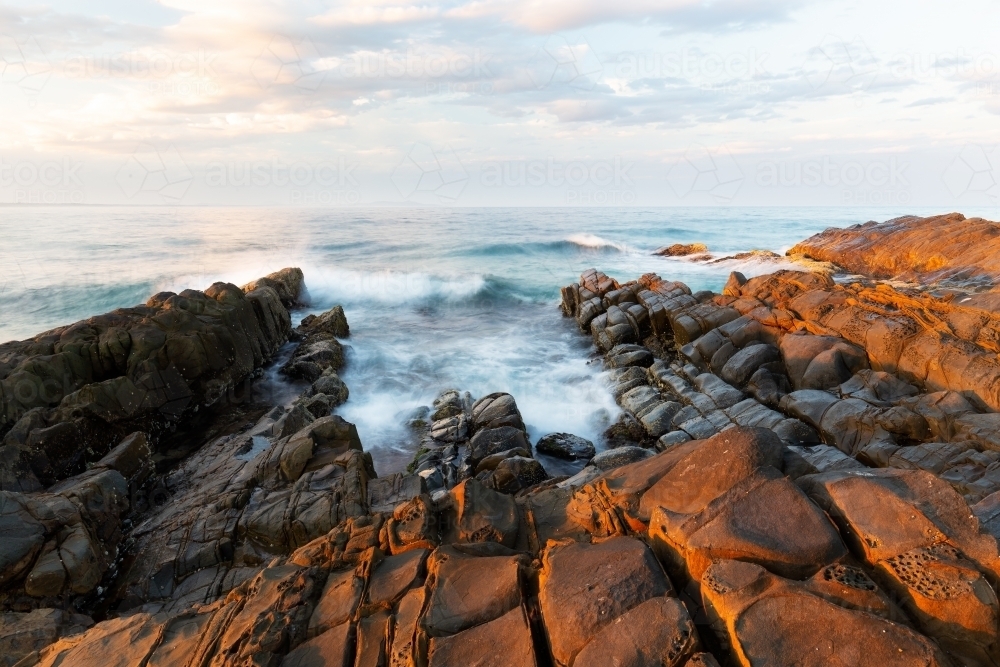 Sunrise on coast of sea - Australian Stock Image