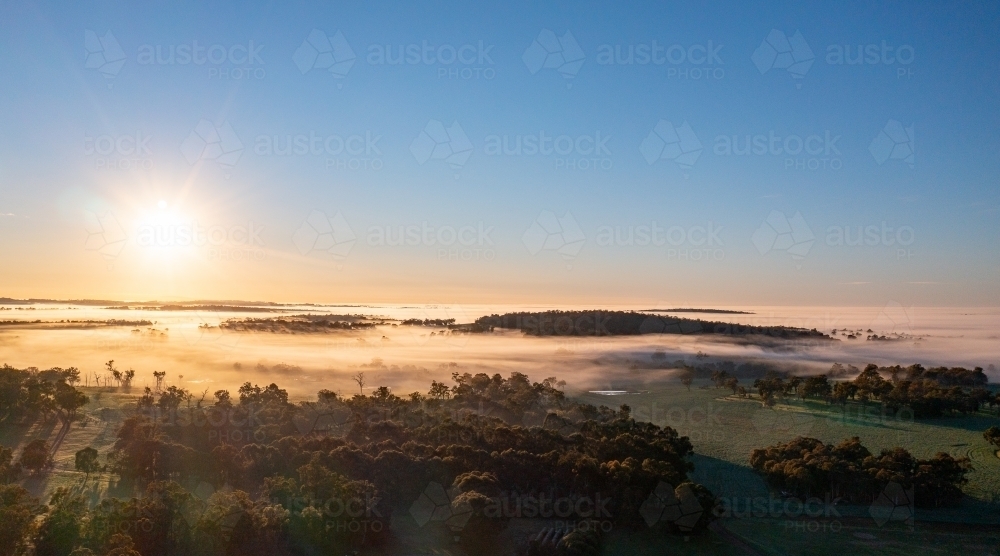 sunrise on misty morning in the countryside - Australian Stock Image