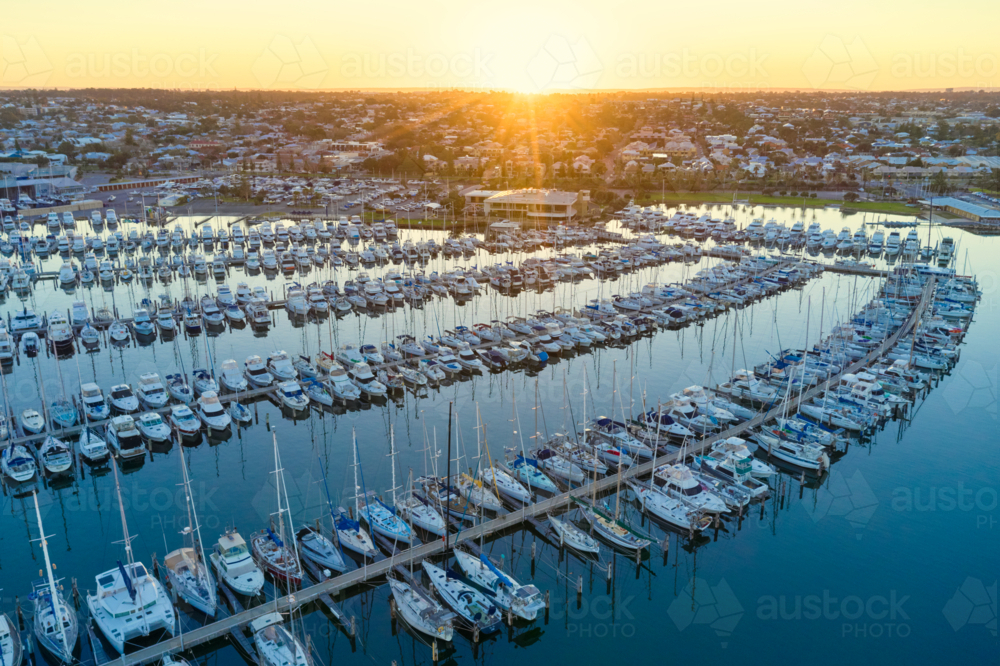 Sunrise on the horizon over a marina in Fremantle, Western Australia - Australian Stock Image