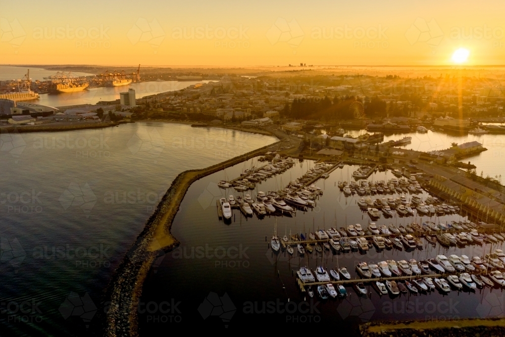 Sunrise on the horizon over Fremantle's challenger harbour marina, city & port in Western Australia - Australian Stock Image