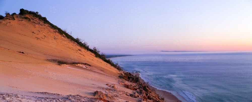 Sunrise over Carlo Sandblow, Inskip Point, and Fraser Island, Queensland. - Australian Stock Image