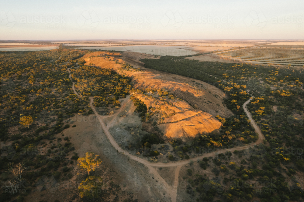 Sunrise over Elachbutting Rock in the eastern Wheatbelt of Western Australia - Australian Stock Image