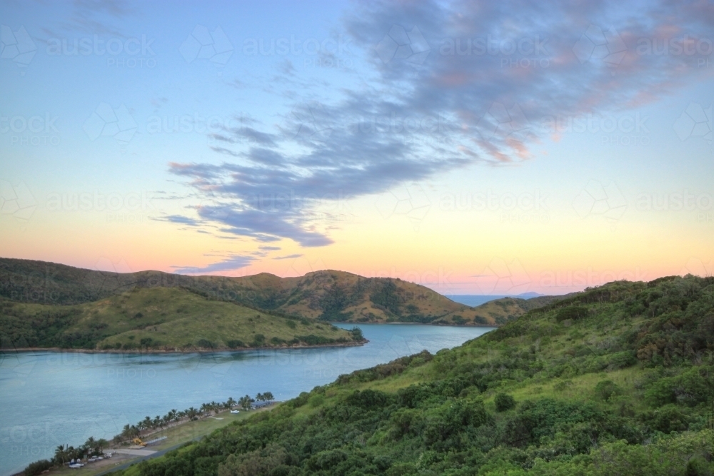 Sunrise over Keswick Island, part of the Whitsundays looking southwards to St Bees Island - Australian Stock Image