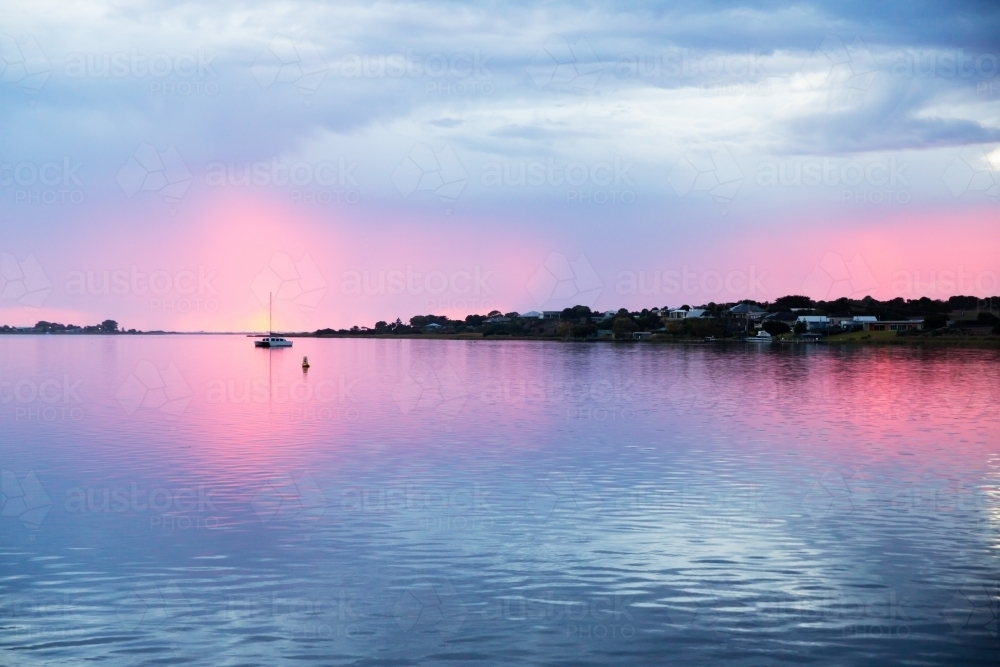 sunrise over river with moored boats - Australian Stock Image