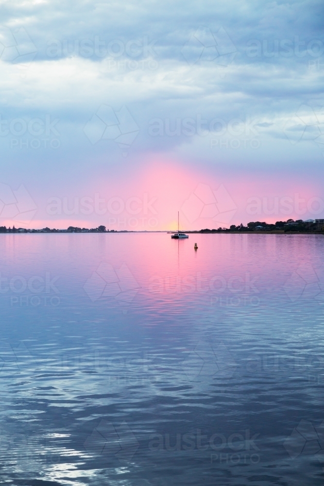sunrise over river with moored boats, vertical - Australian Stock Image