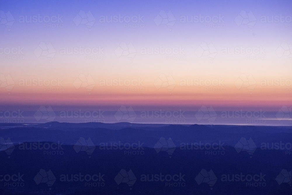 Sunrise overlooking northern NSW from top of Mt Warning - Australian Stock Image