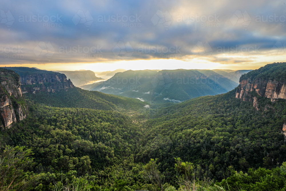 Sunrise view from Govetts Leap in the Blue Mountains overlooking a fog filled valley. - Australian Stock Image