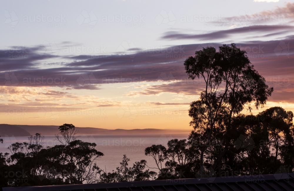 Sunrise view from tree top balcony over Lorne bay in Victoria Australia - Australian Stock Image