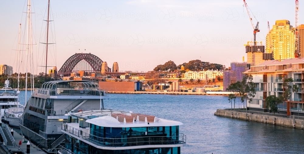 sunset at Pyrmont Bay wharf, with the Harbour Bridge at the horizon - Australian Stock Image