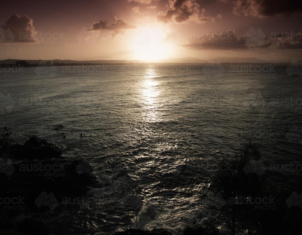 Sunset Byron Bay with surfers - Australian Stock Image