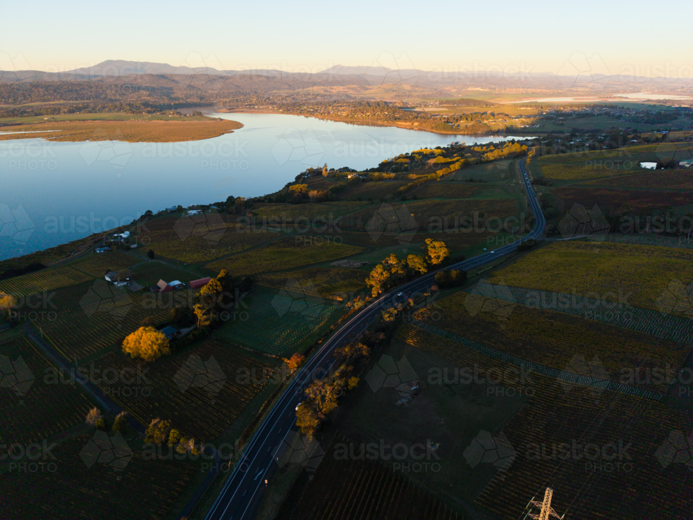 Sunset colours over the River Tamar with the curving West Tamar Highway below - Australian Stock Image