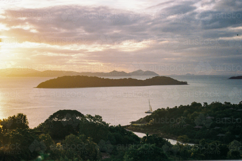 Sunset in Queensland with islands and sail boats in the distance - Australian Stock Image