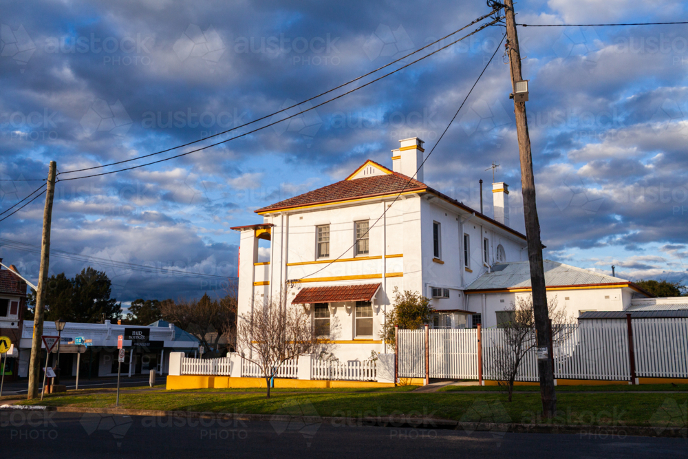 Sunset light illuminating architecture of old building along main street of country town of Merriwa - Australian Stock Image