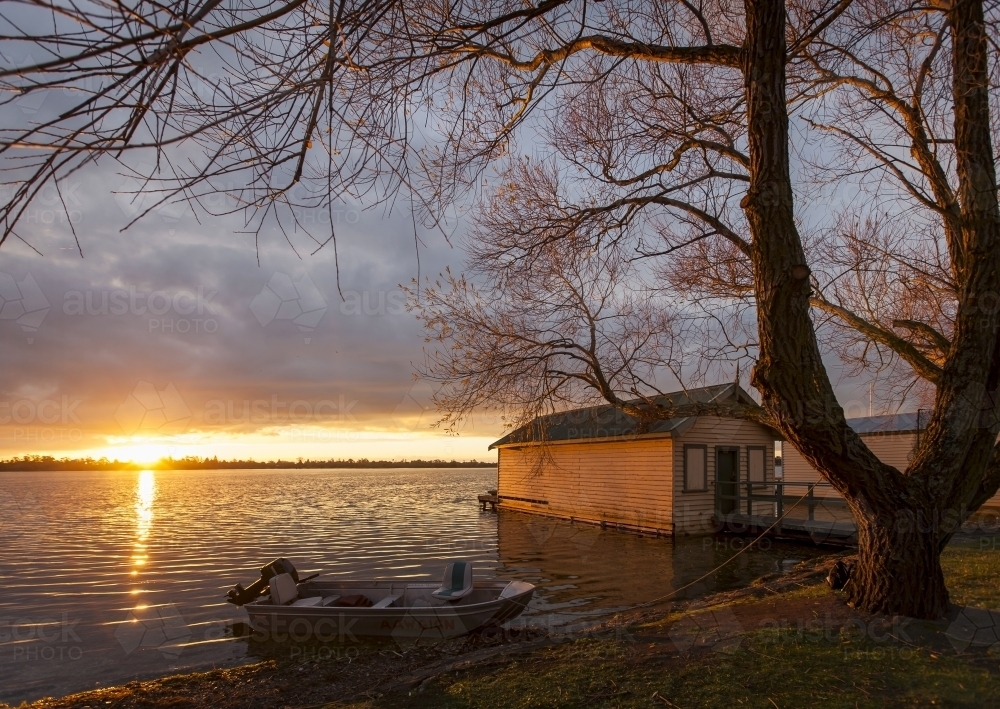 Sunset on lake with old boat sheds - Australian Stock Image