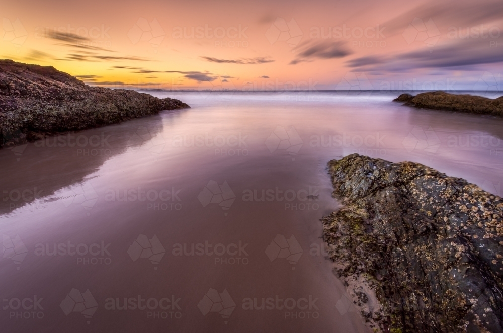 Sunset on still ocean waters - Australian Stock Image