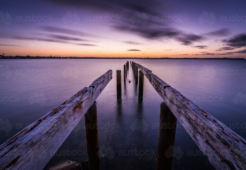 Sunset on the water with ruined pier in foreground - Australian Stock Image