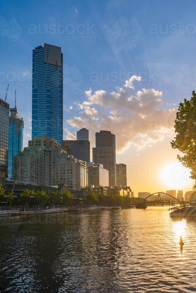 Sunset over an inner city river with high rise buildings along its banks - Australian Stock Image