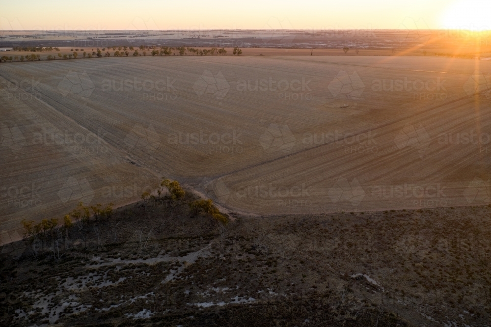 Sunset over dry paddocks on a Wheatbelt farm in Western Australia. - Australian Stock Image