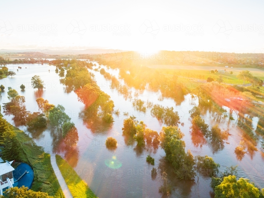 Sunset over floodwaters of Hunter River with broken banks - Australian Stock Image