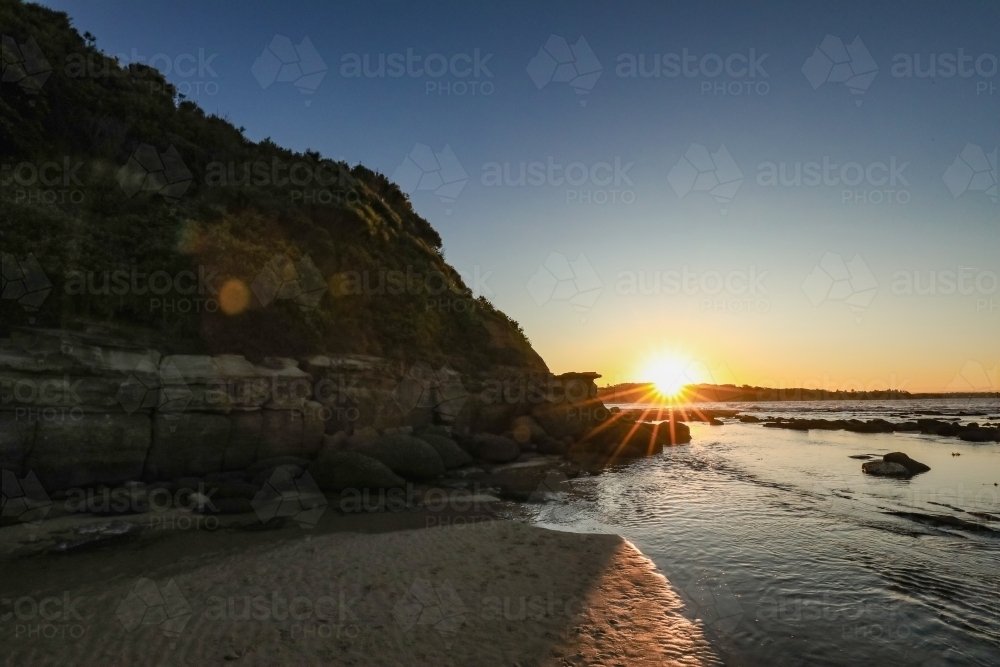 Sunset over rocky shelf at Norah Head, NSW Australia - Australian Stock Image