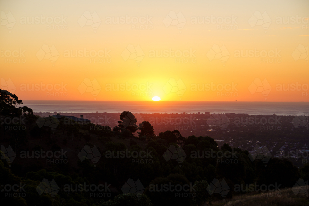 Sunset Over the City of Adelaide and the Ocean from a Hilltop Viewpoint - Australian Stock Image