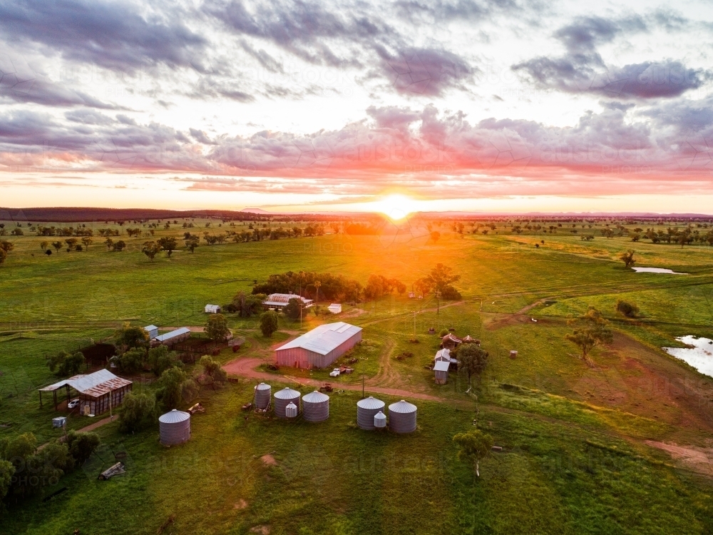 Sunset over tranquil family farm green grass after rain - Australian Stock Image