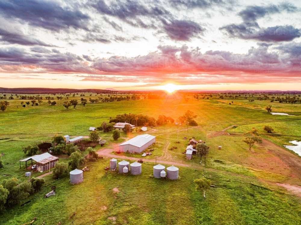 Sunset over tranquil family farm green grass after rain - Australian Stock Image