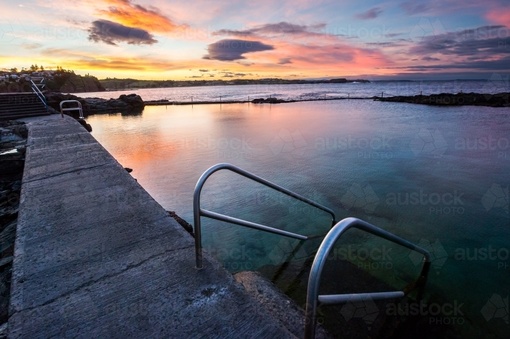 Sunset reflecting in an ocean swimming pool - Australian Stock Image