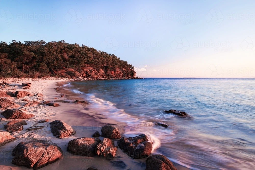 Sunset skies over rocky beach - Australian Stock Image