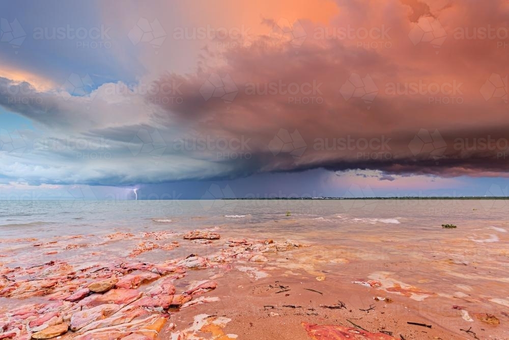 Sunset storm cloud with lightning, Darwin - Australian Stock Image