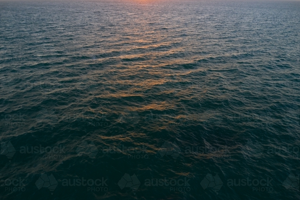 Sunset sunlight reflecting of the ocean's surface - Australian Stock Image