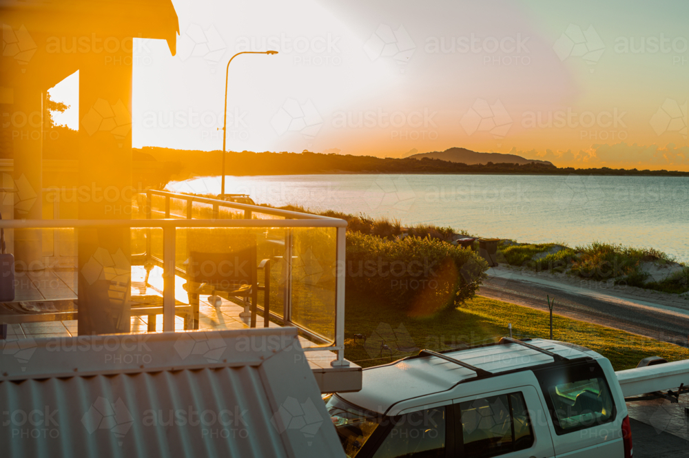 Sunset view of the beach and horizon from a balcony - Australian Stock Image