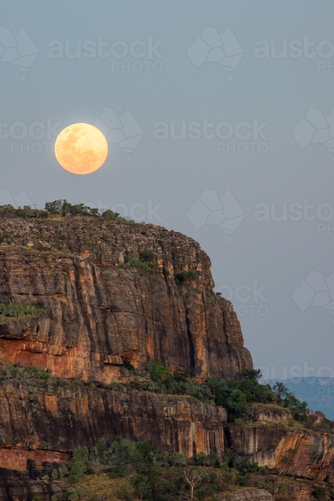 Super moon rising over Nourlangie rock - Australian Stock Image