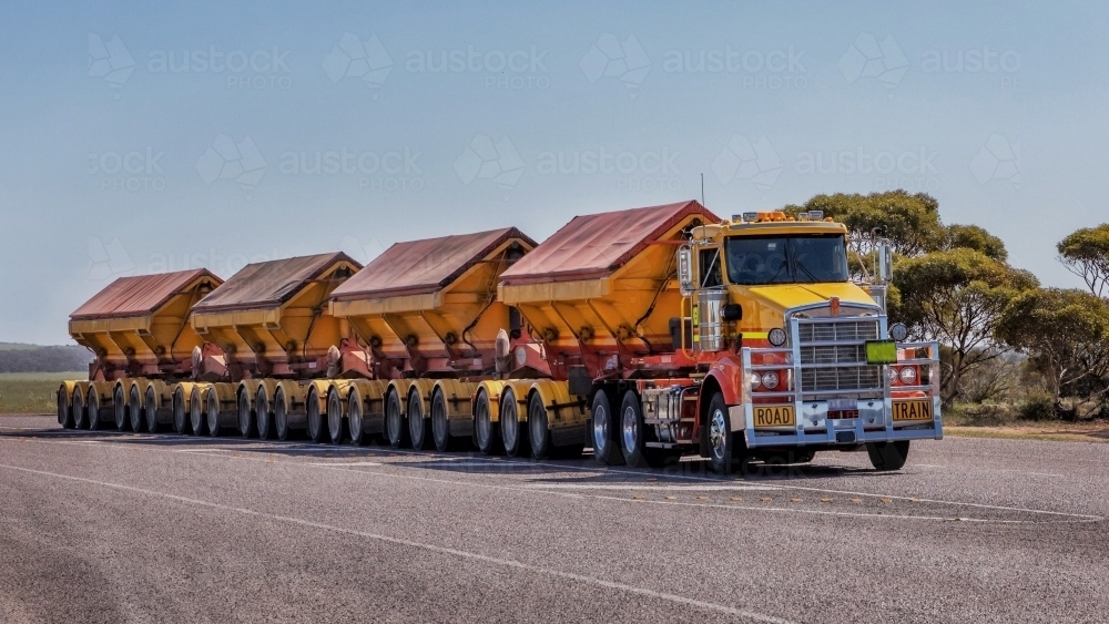 Super Quad Road Train (with 4 trailers) driving on the highway - Australian Stock Image