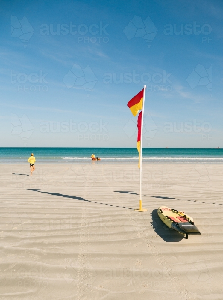 Surf Lifesavers and Flag on Cable Beach - Australian Stock Image