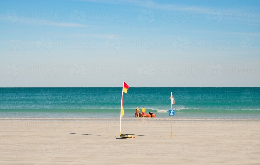 Surf Lifesavers Launching Rubber Dinghy in Cable Beach - Australian Stock Image