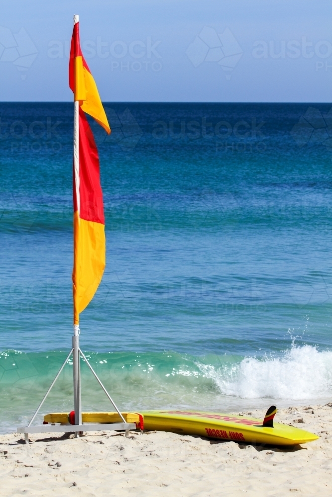 Surf lifesaving flags and board at Kings Beach. - Australian Stock Image