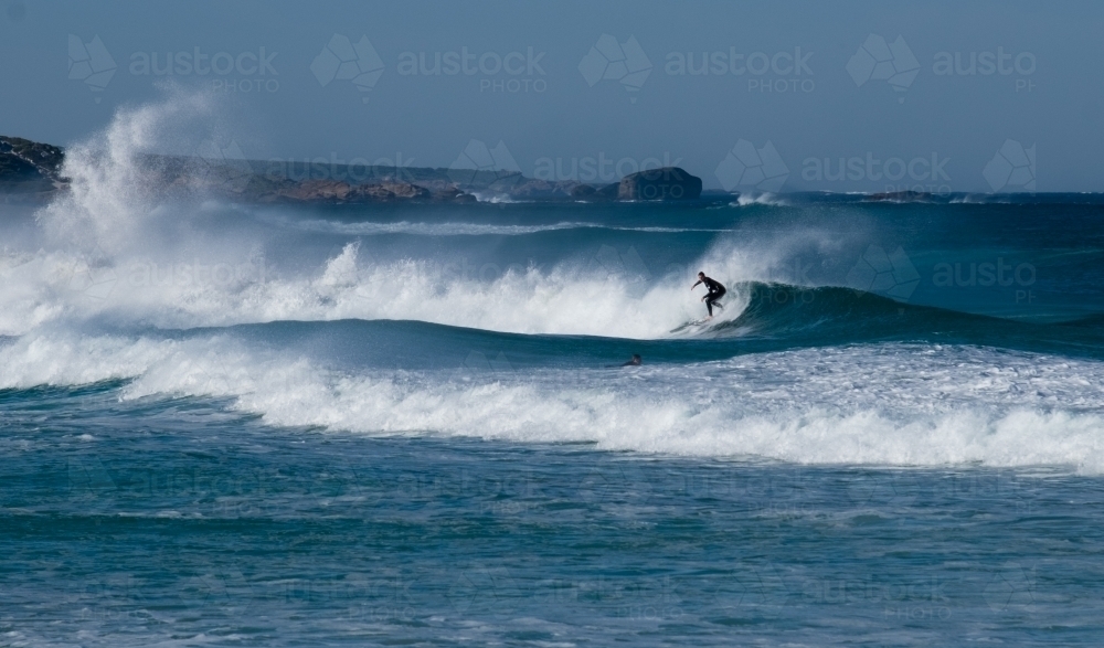 Surfer Captured surfing mid wave on Remote South West Coast - Australian Stock Image