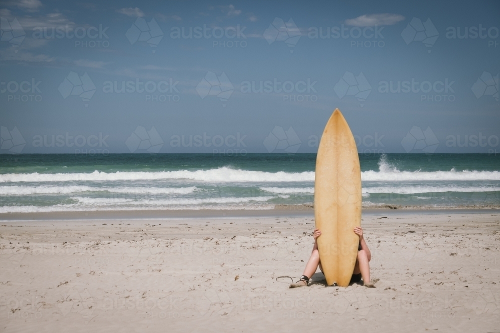Surfer on the beach along the coast of Western Australia - Australian Stock Image