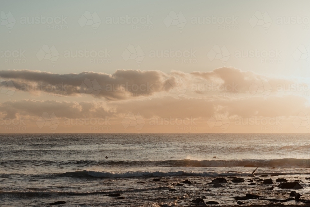 Surfers in the ocean at sunrise at Bronte Beach - Australian Stock Image