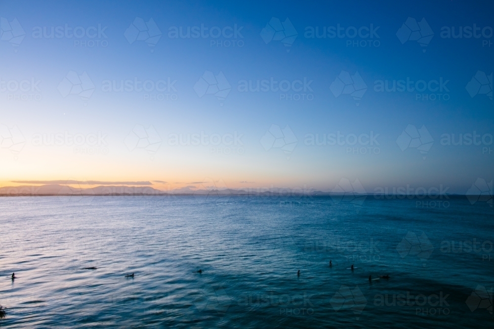 Surfers in the water at The Pass - Australian Stock Image